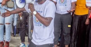 A besaved charity team member on his knees presenting before the events in the camp in Eastern DRC 3