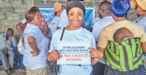 A team volunteer holds a caption for gratitude towards besaved event of distributing the materials to school children in Goma 3