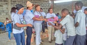 caption shows school children lineup for the materials to be given by Besaved Charity Organization 3
